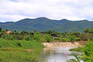 For SaleLandLamphun : Land for sale in Lamphun, Mae Tha District, fronting on a concrete road. The back is next to the water, very beautiful.